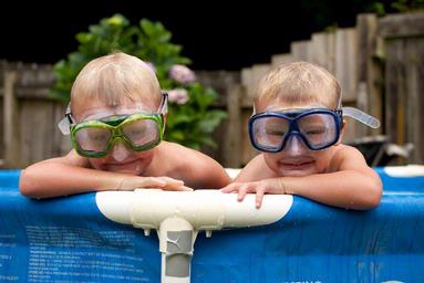  Rick & Jesse Baird play in the pool on a hot summer's evening.